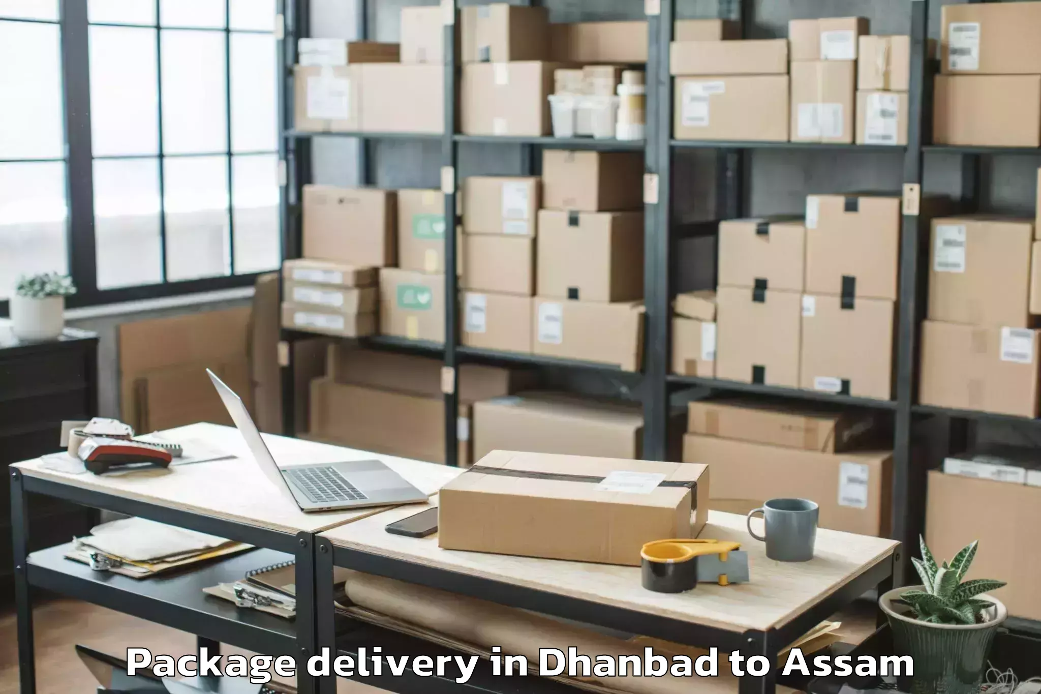 Top Dhanbad to Raha Gaon Package Delivery Available